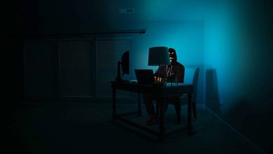 image of man in dark room sat at computer