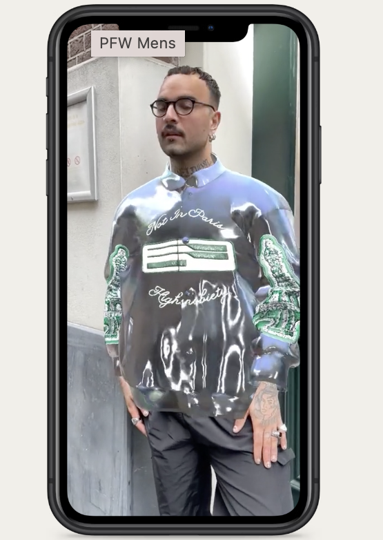 image of a man wearing a digital wearable Varsity Jacket via AR on a smartphone