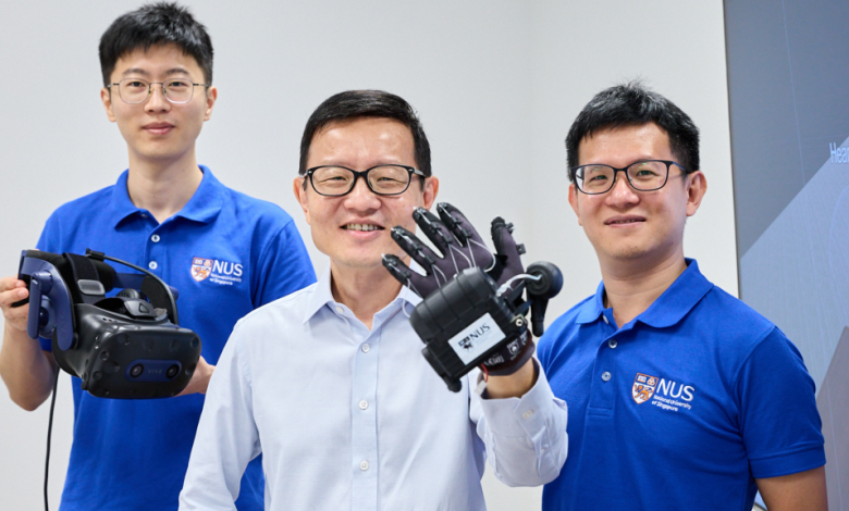 Three men stand before a white background in support of The University of Singapore VR Glove.